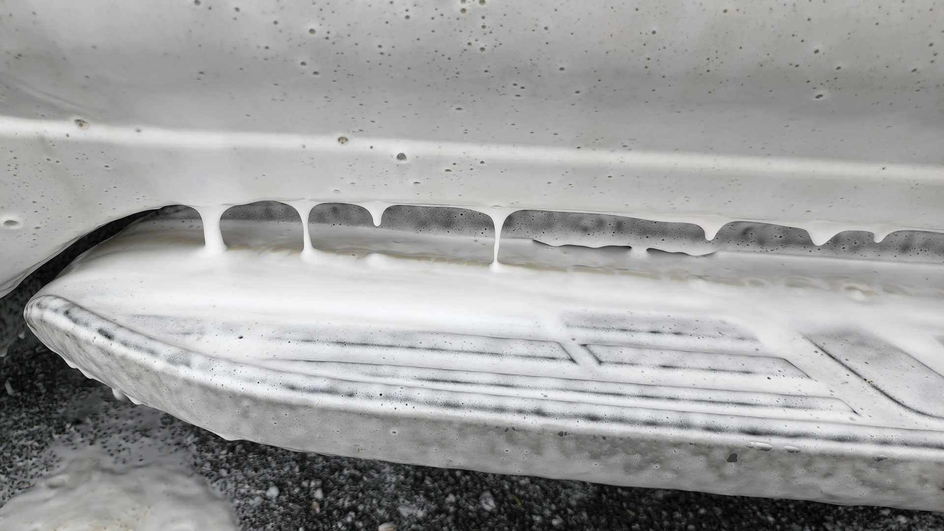 Closeup of vehicle door step being washed